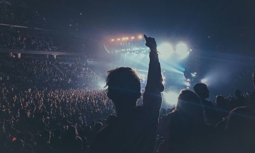 Silhouette crowd enjoying during concert at night