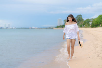 Full length of woman walking on beach