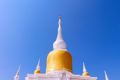 Low angle view of bell tower against blue sky