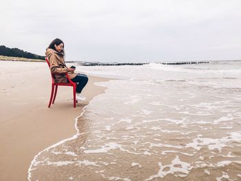 Rear view of woman standing on beach