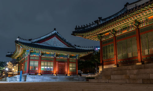 Illuminated temple building against sky at night