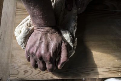 Close-up of hand on wood