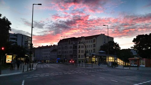 City street against cloudy sky at dusk