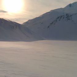 Scenic view of snowcapped mountains against sky during sunset