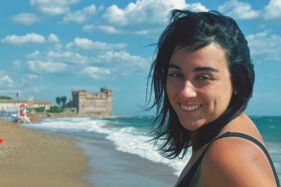 Portrait of smiling young woman on beach