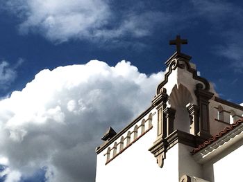 Low angle view of built structure against cloudy sky