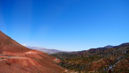 Scenic view of mountains against clear blue sky