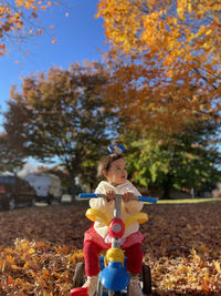 Side view of girl playing with toy on field