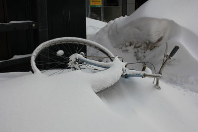 Bicycle buried under snow
