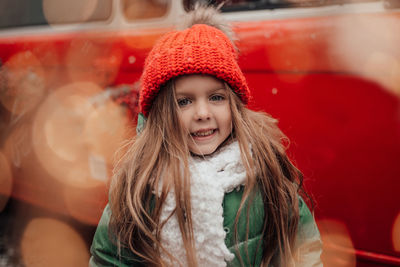 Portrait of smiling young woman standing outdoors