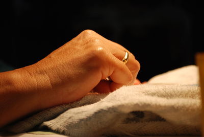 Cropped hand of woman on towel in darkroom