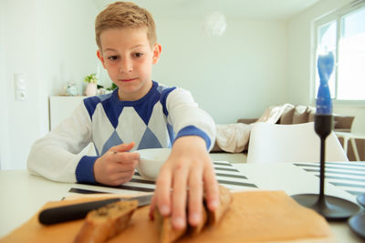 Portrait of boy sitting at table