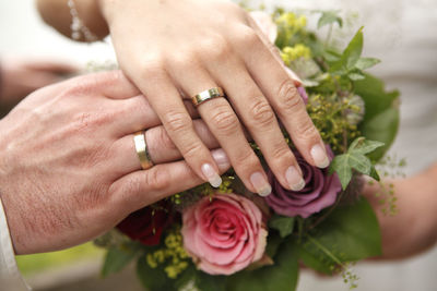 Cropped hands of woman holding flower bouquet