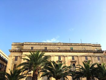 Low angle view of building against blue sky