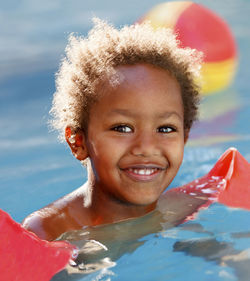 Portrait of smiling boy swimming in pool