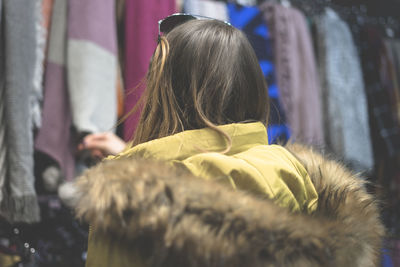 Rear view of woman in clothing store