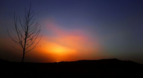 Scenic view of silhouette landscape against sky at sunset