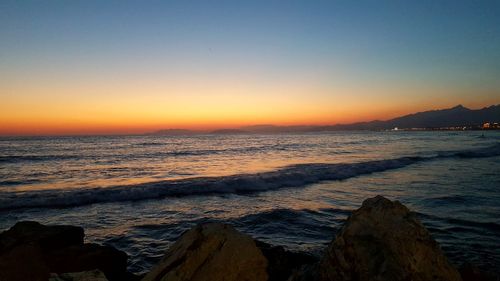 Scenic view of sea against clear sky during sunset