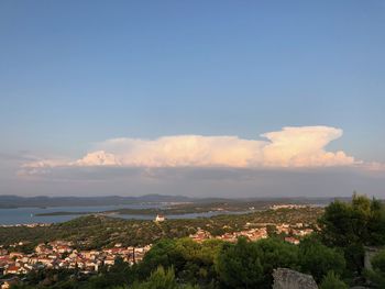 High angle view of townscape by sea against sky
