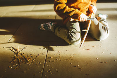 Low section of child on tiled floor