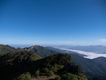 Scenic view of mountains against clear blue sky