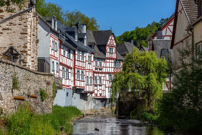 River elz with old bridge and half-timbered houses in monreal, germany