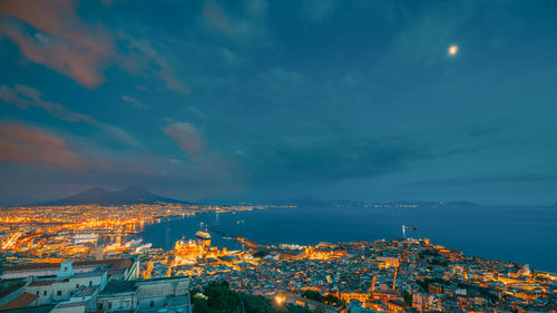 High angle view of city by sea against sky