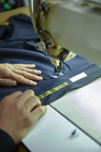 Close-up of hands working with sewing machine