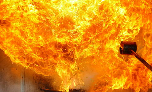 Close-up of yellow fire in factory