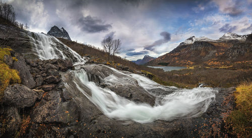 Scenic view of waterfall against sky