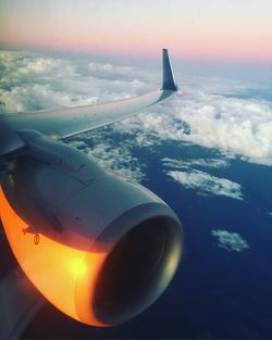 Airplane flying over landscape against sky