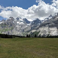 Scenic view of mountains against cloudy sky