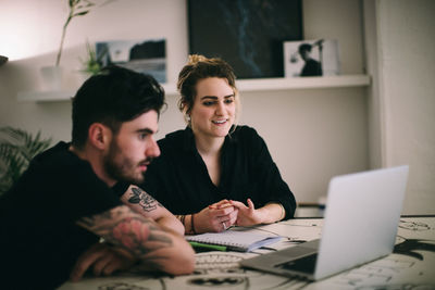 Young couple sitting on table