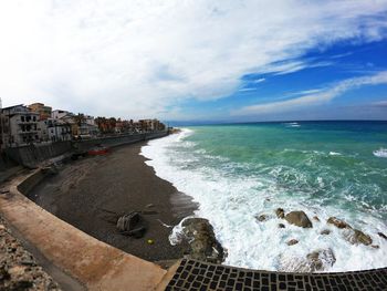 Scenic view of sea against cloudy sky