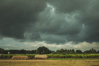 Scenic view of storm clouds over field