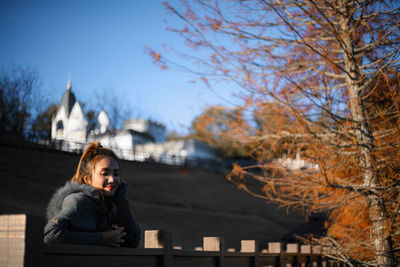 Woman sitting in park during winter