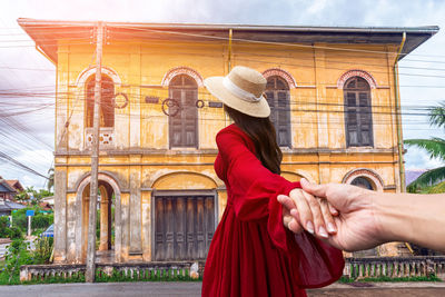 Thai female tourists gaze at ancient architecture french style village in tharae sakon nakhon 