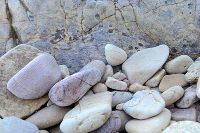 Close up of rounded and polished beach rocks on the sea shore