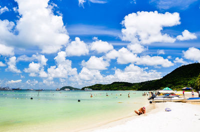 Scenic view of beach against cloudy sky