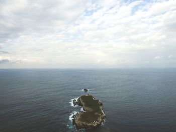 Person in sea against sky