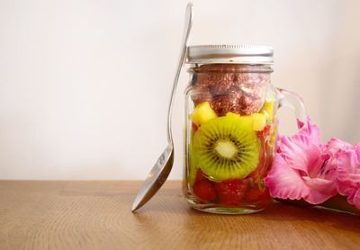 Close-up of flowers in jar on table