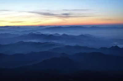 Scenic view of silhouette mountains against sky during sunset