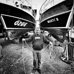 Portrait of man standing in boat