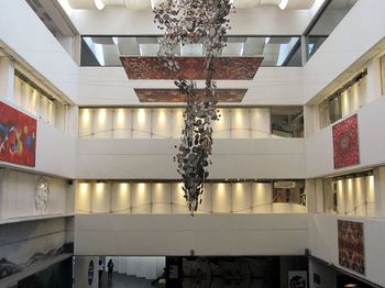 Low angle view of illuminated chandelier hanging in building