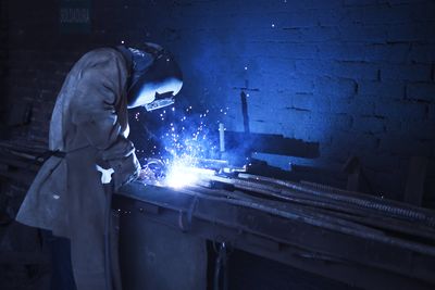 Midsection of man working in workshop