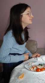 Close-up of woman having food at home