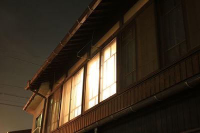 Low angle view of illuminated building against sky