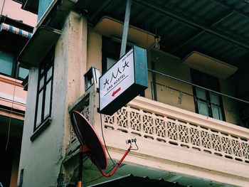 Low angle view of road sign against building