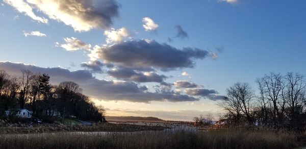 Scenic view of field against sky at sunset