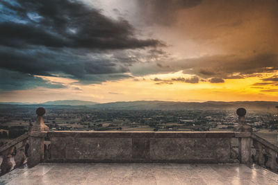 Scenic view of landscape against orange sky